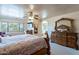 Spacious main bedroom showcasing a vanity, desk, ceiling fan, and decor at 2528 W Mericrest Way, San Tan Valley, AZ 85144
