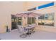 Outdoor patio seating area with an umbrella and sliding glass door at 2528 W Mericrest Way, San Tan Valley, AZ 85144