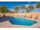 Sparkling pool with ample seating and lush desert landscaping, perfect for outdoor relaxation and entertainment at 2528 W Mericrest Way, San Tan Valley, AZ 85144