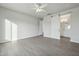 Main bedroom with wood-look tile floors and sliding barn doors leading to the bathroom at 27412 N 256Th Dr, Wittmann, AZ 85361