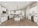 Bright kitchen with white cabinetry, stainless appliances, large island and bar stool seating at 3334 W Williams Dr, Phoenix, AZ 85027