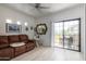 Bright living room with sliding glass doors to patio and stylish decor at 3434 E Baseline Rd # 259, Phoenix, AZ 85042