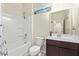 Bright bathroom featuring a shower-tub combo, white toilet, and neutral vanity with a large mirror at 35421 W San Alvarez Ave, Maricopa, AZ 85138