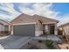 Front exterior featuring a cozy porch area and a well-maintained yard, enhancing the property's charm at 35421 W San Alvarez Ave, Maricopa, AZ 85138