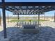 Shaded pavilion with seating area, offering a comfortable space to relax and socialize in the community at 36820 W San Clemente St, Maricopa, AZ 85138