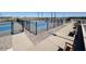 Modern pickleball courts, ready for play, with sleek black fencing and comfortable seating areas for players at 36820 W San Clemente St, Maricopa, AZ 85138