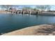 Scenic view of the community pond, featuring a small dam with cascading water and a lakeside gazebo at 36820 W San Clemente St, Maricopa, AZ 85138