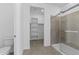 Bathroom showcasing a tiled walk-in shower, a toilet, and a walk-in closet at 37053 W La Paz St, Maricopa, AZ 85138
