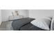 Cozy bedroom with plush bedding and a sleek dresser, offering a tranquil retreat at 37053 W La Paz St, Maricopa, AZ 85138