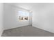 Bedroom featuring a large window, carpeted floors, and neutral paint at 37053 W La Paz St, Maricopa, AZ 85138