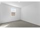 Bedroom featuring a large window, carpeted floors, and neutral paint at 37053 W La Paz St, Maricopa, AZ 85138