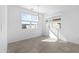 Bright dining area with large windows, tile flooring, and modern chandelier at 37053 W La Paz St, Maricopa, AZ 85138