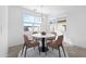 Bright dining area features a modern table set and large windows, perfect for gatherings at 37053 W La Paz St, Maricopa, AZ 85138