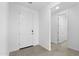 Bright, neutral entryway with white walls and tile flooring at 37053 W La Paz St, Maricopa, AZ 85138