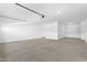 Spacious garage offers ample room for vehicles and storage, illuminated by recessed lighting at 37053 W La Paz St, Maricopa, AZ 85138