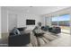 The living room offers stylish seating, a sleek TV setup, and access to outdoor space at 37053 W La Paz St, Maricopa, AZ 85138