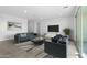 Contemporary living area featuring modern furnishings and an open layout into the kitchen space at 37053 W La Paz St, Maricopa, AZ 85138