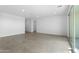 Bright, open living space with tile flooring and sliding glass door access to the backyard at 37053 W La Paz St, Maricopa, AZ 85138