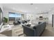 Bright, open-concept living room with modern furniture and a seamless flow to the kitchen at 37053 W La Paz St, Maricopa, AZ 85138