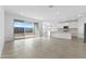 Open floor plan with tile flooring, a living room with a slider door, and a modern kitchen at 37053 W La Paz St, Maricopa, AZ 85138