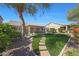 Backyard with manicured lawn, pavers and desert landscaping for elegant outdoor living at 3777 N 162Nd Ave, Goodyear, AZ 85395