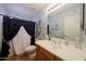Well-lit bathroom with a vanity, commode and a shower with blue accents at 3777 N 162Nd Ave, Goodyear, AZ 85395