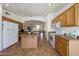Traditional kitchen with wooden cabinets, appliances and an open view to living area at 3777 N 162Nd Ave, Goodyear, AZ 85395