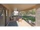 Relaxing covered patio with seating and view of the backyard at 3777 N 162Nd Ave, Goodyear, AZ 85395
