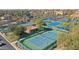 Active community featuring multiple tennis courts surrounded by lush landscaping and mature trees at 3777 N 162Nd Ave, Goodyear, AZ 85395