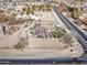 An aerial view of a home with a long dirt lot and a road off to the side at 4302 W Dobbins Rd, Laveen, AZ 85339