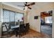 Charming dining room with a ceiling fan and a window with patterned curtains at 4302 W Dobbins Rd, Laveen, AZ 85339