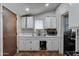 Modest kitchen featuring white cabinets, sink and a window at 4302 W Dobbins Rd, Laveen, AZ 85339