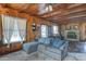 Inviting living room with wood walls, stone fireplace, and comfortable seating at 4302 W Dobbins Rd, Laveen, AZ 85339