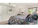 Tranquil bedroom offers a cozy quilt, a window, and a carpeted floor at 5877 N Granite Reef Rd # 2203, Scottsdale, AZ 85250