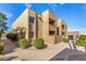 Condominium exterior view showcasing lush landscaping and concrete sidewalks at 5877 N Granite Reef Rd # 2203, Scottsdale, AZ 85250
