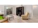 A cozy living area with a view of the balcony, a comfortable sofa, and a media center at 5877 N Granite Reef Rd # 2203, Scottsdale, AZ 85250