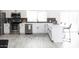 Bright kitchen with stainless steel appliances, a large central island, and stylish black and white backsplash at 6621 E Sharon Dr, Scottsdale, AZ 85254