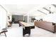 Open-concept living area with a shuffleboard table, comfortable seating, and seamless flow to the dining area at 6621 E Sharon Dr, Scottsdale, AZ 85254