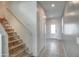 Hallway with gray walls, tile flooring, and a staircase leading to the second floor at 6815 W Encinas Ln, Phoenix, AZ 85043