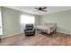 Bedroom with wood-look floors, ceiling fan and reading chair at 7061 E Broadway Rd # 48, Mesa, AZ 85208