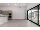 Open-concept kitchen featuring a large island, modern appliances, and a sliding glass door at 7070 E Lowden Dr, Scottsdale, AZ 85266