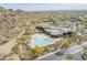 Aerial view of community pool and clubhouse surrounded by desert landscape at 7321 E Crimson Sky Trl, Scottsdale, AZ 85266