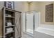 An organized bathroom with glass enclosed shower, tub, and linen storage at 7321 E Crimson Sky Trl, Scottsdale, AZ 85266