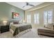 Comfortable bedroom with a ceiling fan, natural light, and a lounge chair at 7321 E Crimson Sky Trl, Scottsdale, AZ 85266