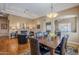 Inviting dining area with elegant lighting, wood floors, and seamless flow to the living room at 7321 E Crimson Sky Trl, Scottsdale, AZ 85266