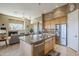 Open kitchen with a stainless steel refrigerator, kitchen island, and easy access to the living area at 7321 E Crimson Sky Trl, Scottsdale, AZ 85266