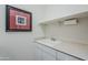 Laundry room featuring white cabinetry, countertop, and utility sink at 7321 E Crimson Sky Trl, Scottsdale, AZ 85266