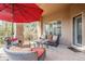 Covered patio featuring comfortable seating and a red umbrella at 7321 E Crimson Sky Trl, Scottsdale, AZ 85266