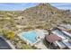 Aerial view of a community pool surrounded by lounge chairs and lush desert landscaping at 7321 E Crimson Sky Trl, Scottsdale, AZ 85266