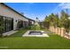 Beautiful backyard featuring a decorative water feature, landscaped lawn, and privacy screens at 7508 E Laredo Ln, Scottsdale, AZ 85250